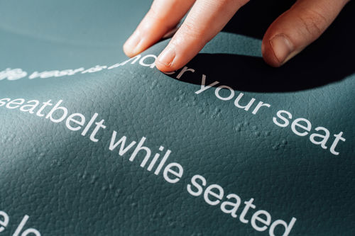 Aviation seat cover with braille
